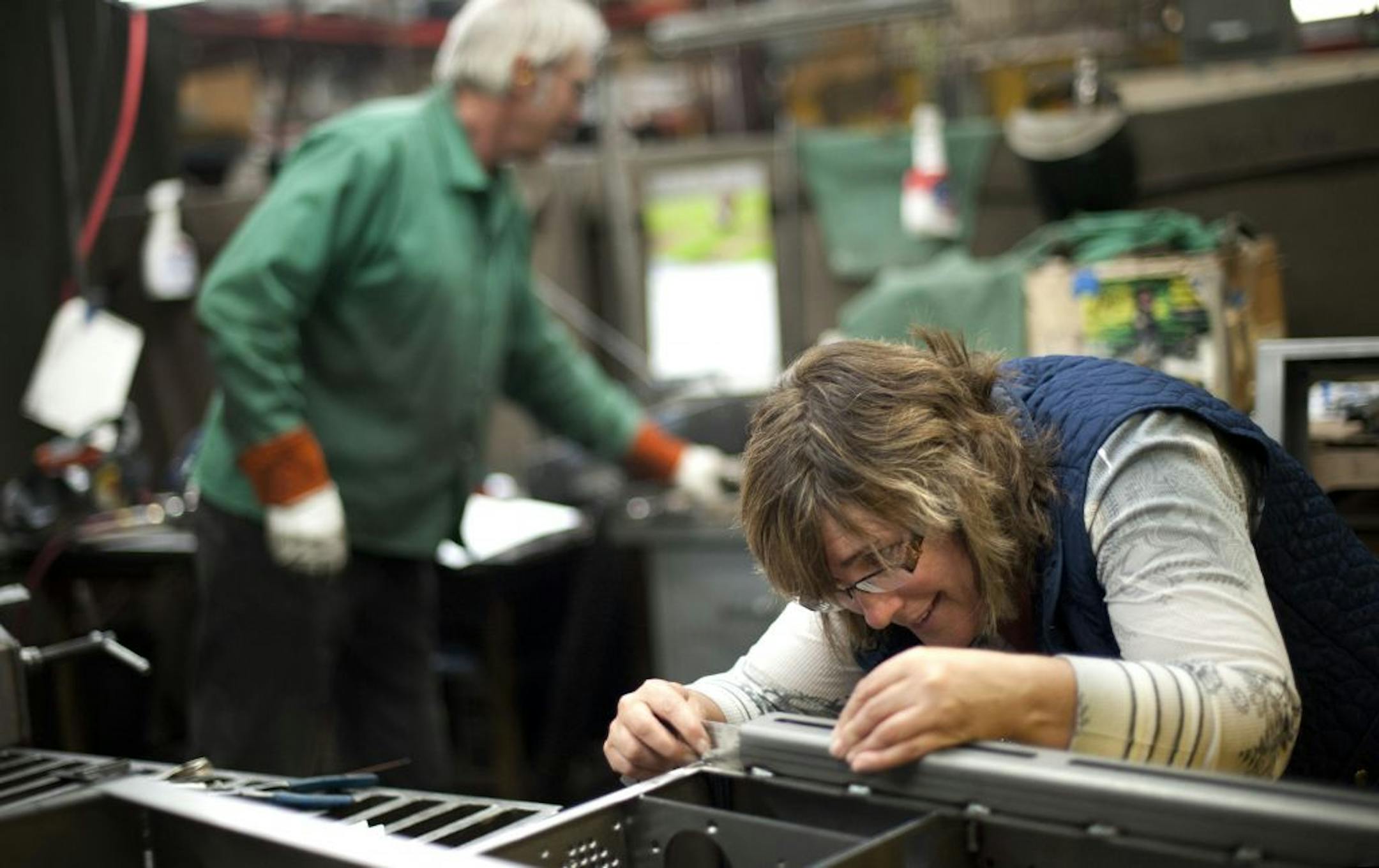Anna Wald earned her credentials as a certified welding inspector and works with Traci and Lori Tapani, sisters and co-presidents of Wyoming Machine. Behind her is welder Bill Damon, she is inspecting welds that Bill made. Wednesday, April 11, 2012