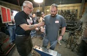 Ken Zitur, left, of Ken's Custom Iron, gave a lesson in blacksmithing to a group of military veterans, including Army Veteran Aaron Othoudt, cq, of Fo