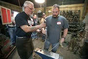 Ken Zitur, left, of Ken's Custom Iron, gave a lesson in blacksmithing to a group of military veterans, including Army Veteran Aaron Othoudt, cq, of Fo