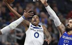 The Minnesota Timberwolves' Jeff Teague (0) puts up a shot in the third quarter as he's defended by the Oklahoma City Thunder's Steven Adams (12) on W