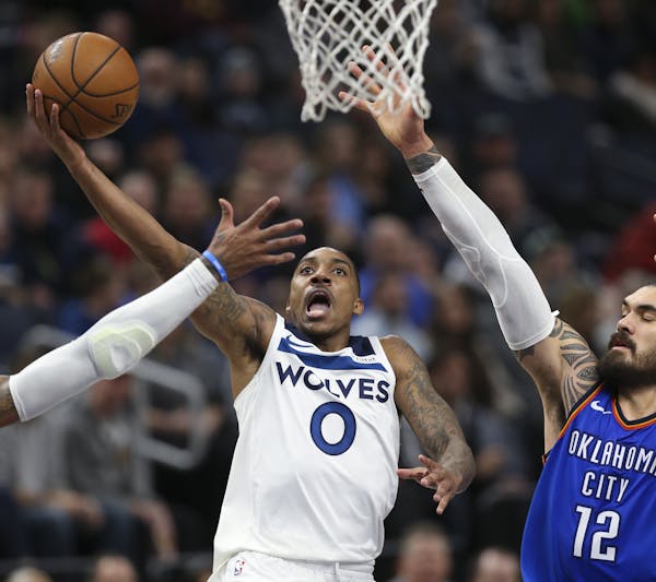 The Minnesota Timberwolves' Jeff Teague (0) puts up a shot in the third quarter as he's defended by the Oklahoma City Thunder's Steven Adams (12) on W