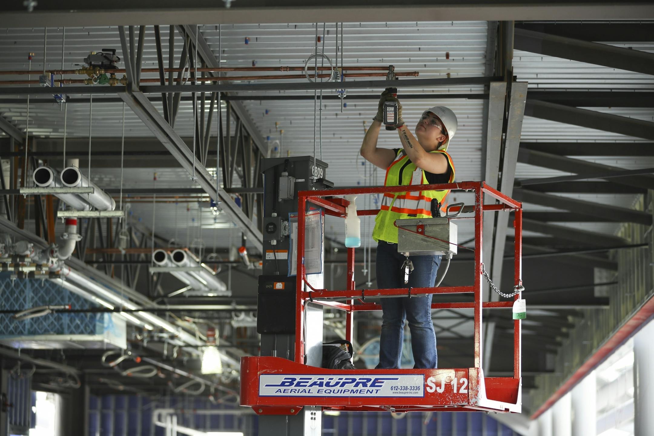 Rose O'Phelan, an apprentice pipe fitter who works for Harris Companies, capped the ends of copper pipes that will heat suites at Allianz Field.