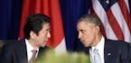 U.S. President Barack Obama, right, and Japan&#xed;s Prime Minister Shinzo Abe, left, talk during a bilateral meeting at the Asia-Pacific Economic Coo