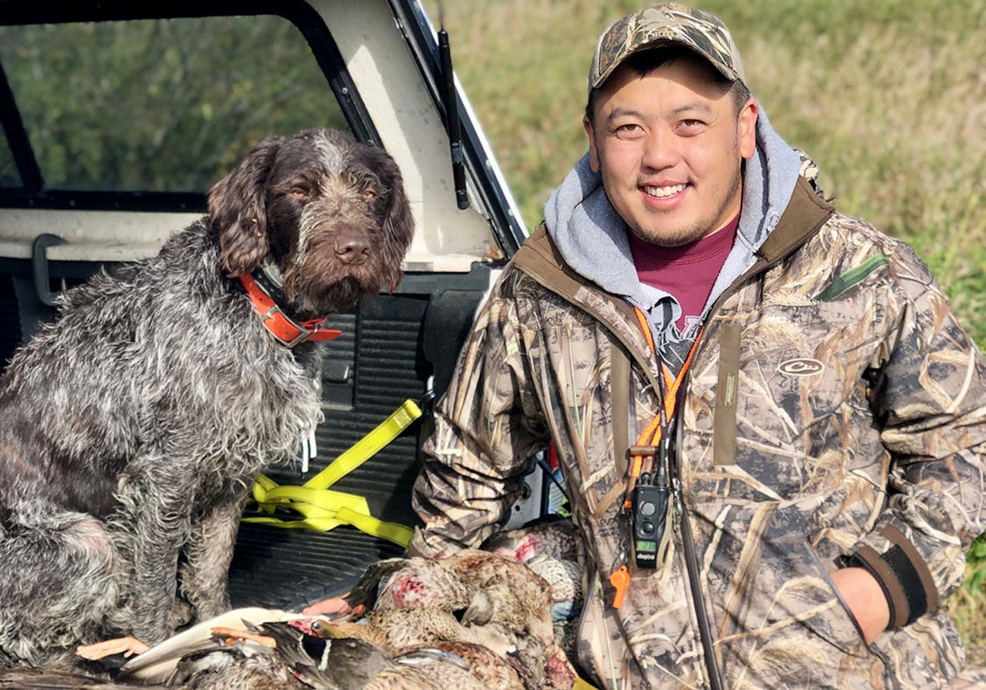 Keng Yang and his dog Kaiya after a successful waterfowl hunt