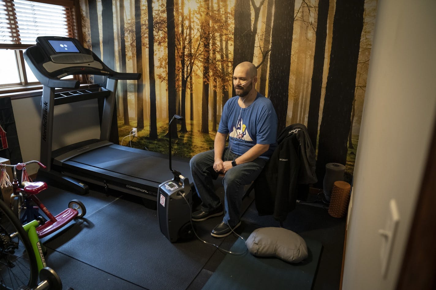 Ben O'Donnell rested after he walked on his treadmill to regain his strength at his home in Anoka County on Friday, April 17, 2020. He uses an oxygen machine when he does any physical activity like walk or climb stairs.