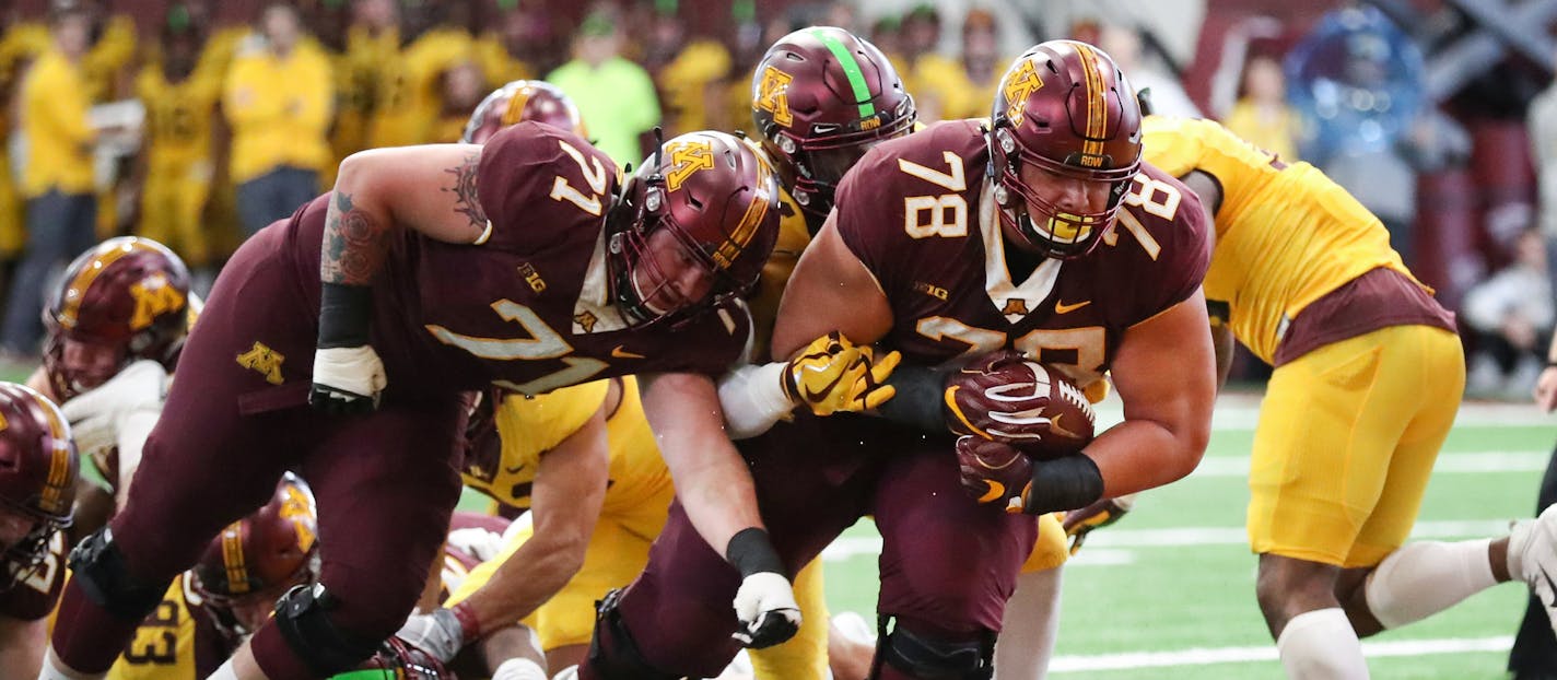 Daniel Faalele, 6-9 and 400 pounds, broke a handful of tackles to score on a 6-yard run for the Maroon team on Saturday. "He just kept moving his feet, and 400 pounds later he's in the end zone," coach P.J. Fleck said.