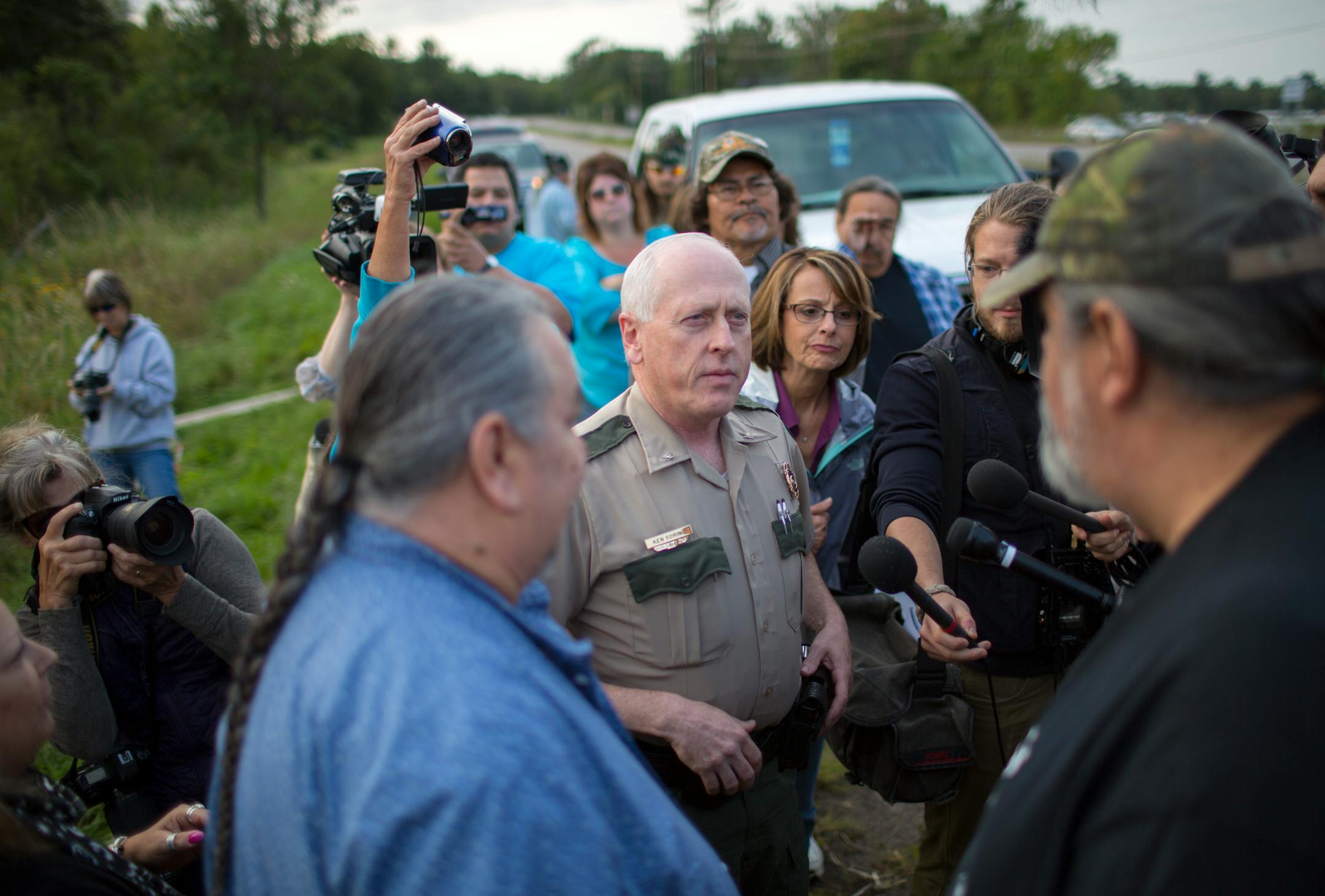 FILE - DNR Enforcement Chief Ken Soring presented a one day use permit to the Chippewa band preparing to enter Hole In The Day Lake for wild ricing in August. Soring is recently retired.