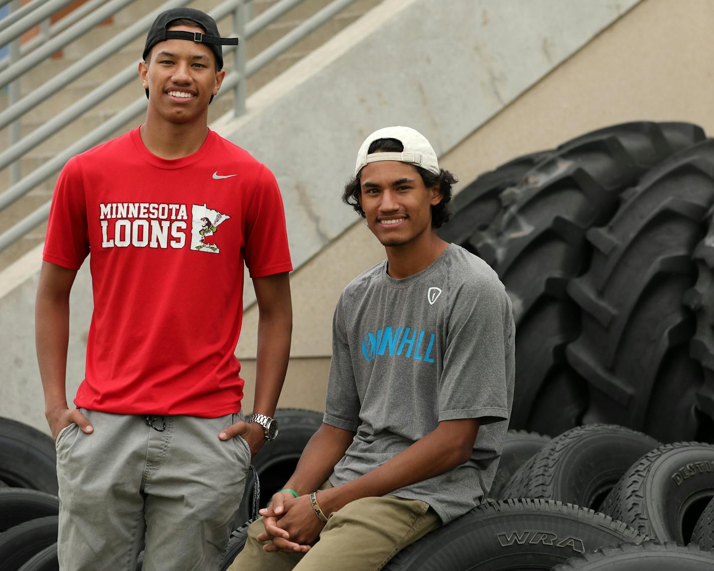 Dayton and Dante Buck posed for a portrait Wednesday at Farmington High School. ] ANTHONY SOUFFLE &#xef; anthony.souffle@startribune.com Brothers Dante and Dayton Buck posed for a portrait Wednesday, May 10, 2017 at Farmington High School in Farmington, Minn. The two attend Farmington High School which has joined Burnsville, Lakeville, Shakopee, and Prior Lake-Savage school districts, along with Shakopee Mdewakanton Sioux Community to form the South of The River Pow-wow to honor graduating Ameri