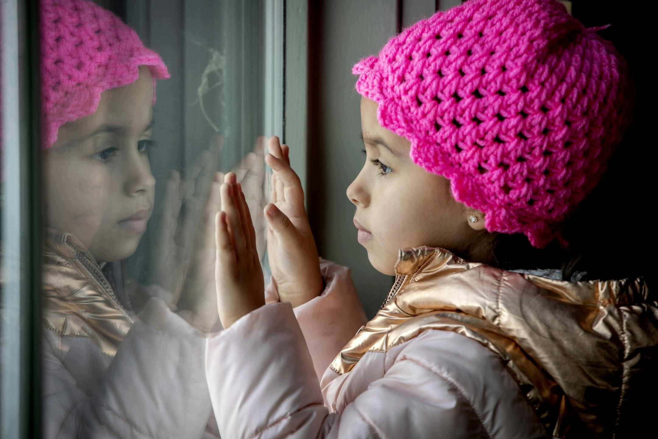 Irianis Colon Lopez, 5, looked through a window out at the snow as her parents filled out voter registration forms with help from their English teacher at a coffee shop, Monday, February 17, 2020 in Roseau, MN.