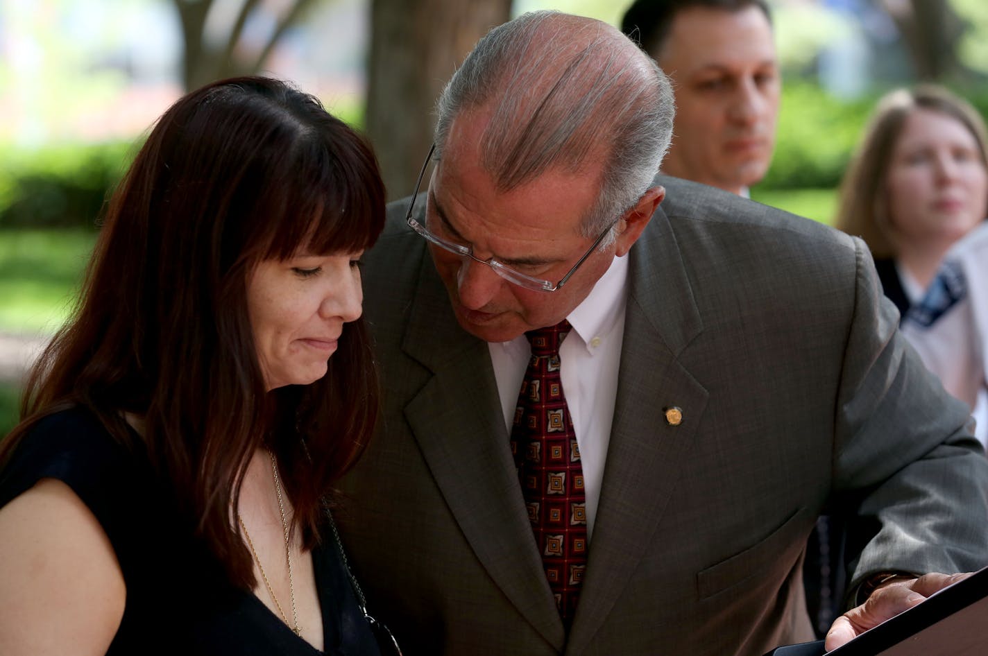 Hennepin County Attorney Mike Freeman talked with Dawn Baity, sister of Dustin Baity, before answering questions during the press conference. ] (KYNDELL HARKNESS/STAR TRIBUNE) kyndell.harkness@startribune.com Hennepin County attorney's office to announce charges in cold case involving double homicide, of Carrie Ritcher and Dustin Baity in Minneapolis at the south end of the Hennepin County Government Center in Minneapolis, Min. Wednesday, July 9, 2014.