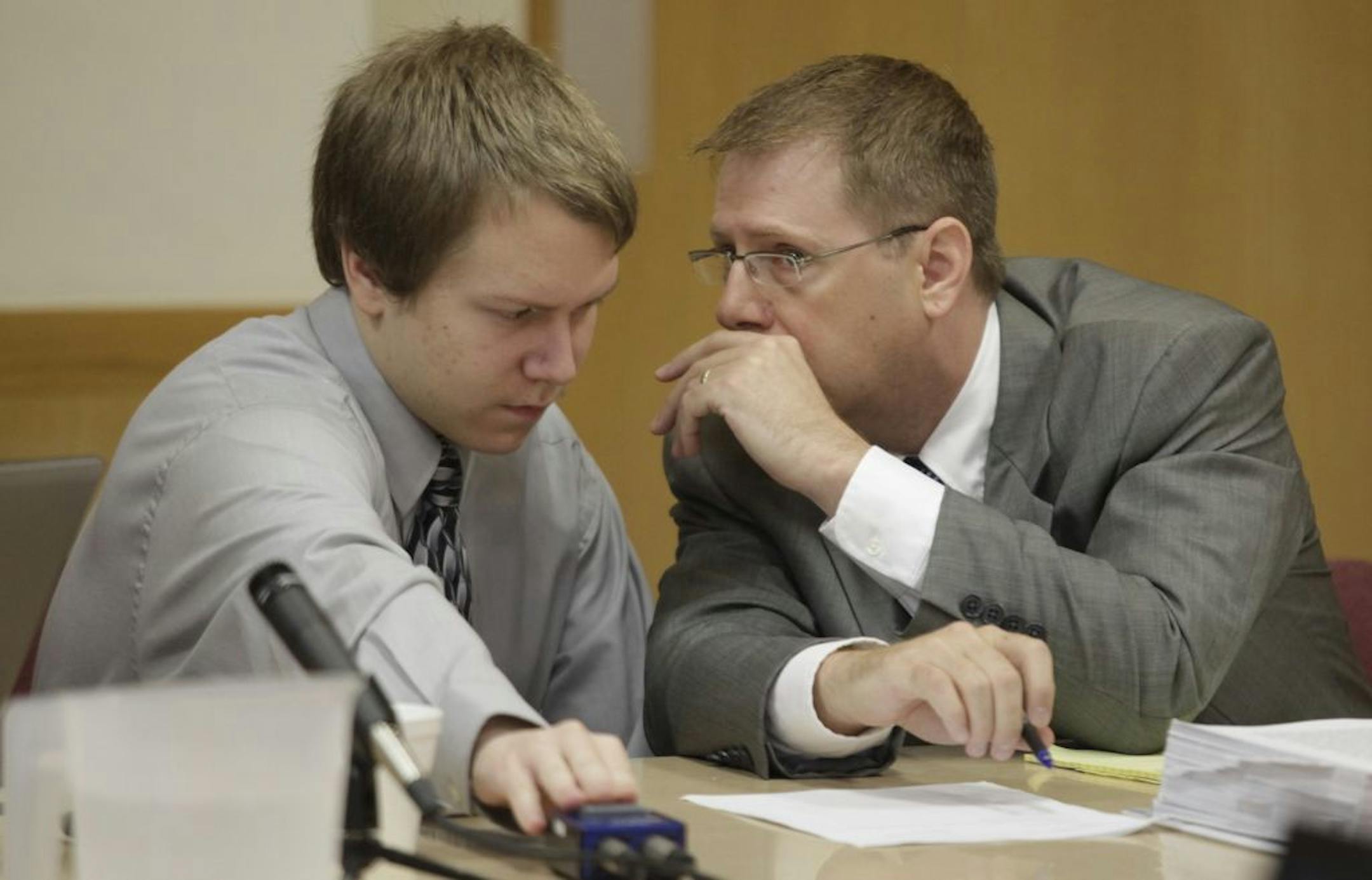Michael Swanson, left, conferred with defense attorney Charles Kenville during his first-degree murder trial in Carroll County, Iowa.