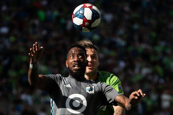 Minnesota United defender Romain Metanire (19) and Seattle Sounders forward Jordan Morris (13) compete for a header during the final game of the regul