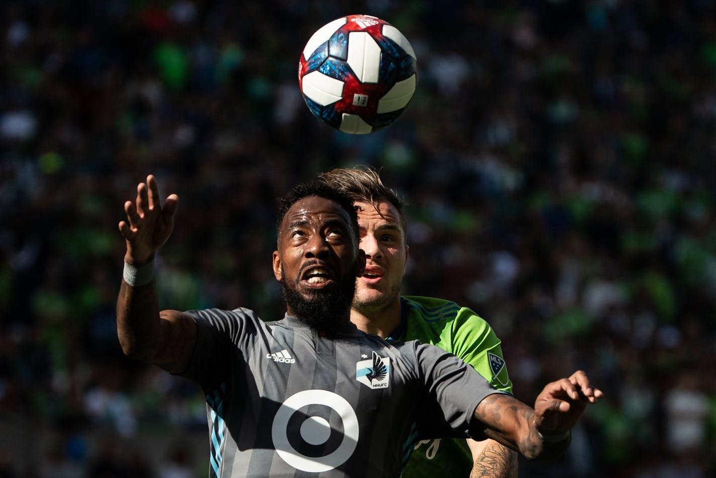 Minnesota United defender Romain Metanire (19) and Seattle Sounders forward Jordan Morris (13) compete for a header during the final game of the regular season between the Seattle Sounders and Minnesota United at CenturyLink Field in Seattle on October 6, 2019. 211716 ORG XMIT: 211716