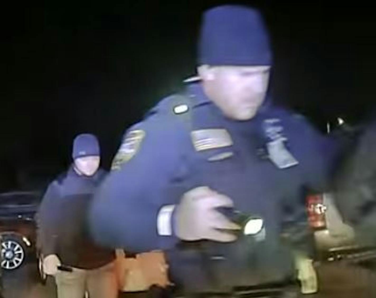 Squad car video shows civilian Evan Eggers, background, accompanying Officer Mark Riley in the apprehension of Kelvin Rodriguez. Credit: Provided by the ACLU of Minnesota