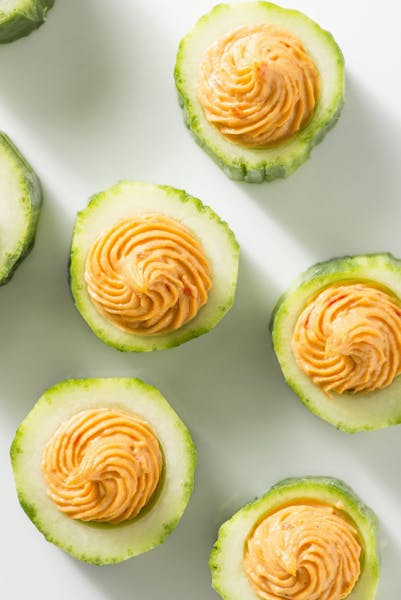 With the new year many people vow to adopt better eating habits. These roasted red pepper hummus in cucumber cups are from Giada de Laurentis' "Feel G