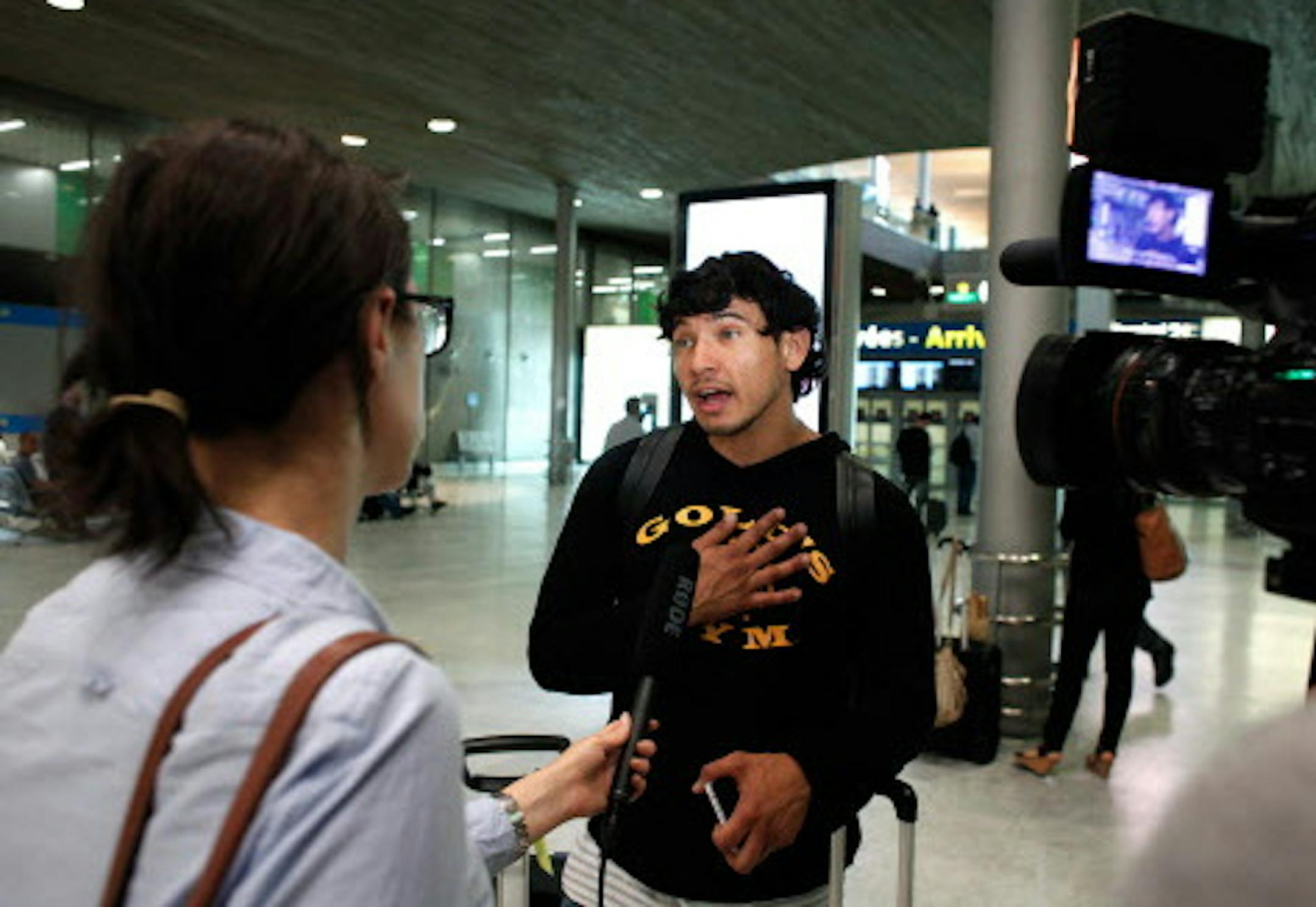 A passenger from the diverted Delta Air Lines flight 468 from New York to Tel Aviv, Marlon Pelayo, 28, from Los Angeles, talks to an Associated Press journalist, in Roissy Charles de Gaulle airport, north of Paris, Tuesday, July 22, 2014. Delta Air Lines is canceling all flights to Israel until further notice, citing reports that a rocket landed near Tel Aviv's Ben Gurion Airport. A Delta Boeing 747 from New York was flying over the Mediterranean headed for Tel Aviv on Tuesday when it turned aro