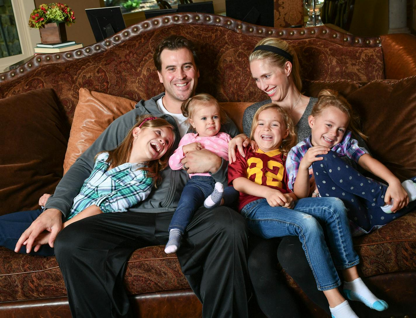 Ben Utecht and wife Karyn at home in Lakeville with their daughters Elleora, 7; Haven, 1, and Amy and Kate, both 5. Ben, who played for the Minnesota Gophers and Super Bowl champion 2007 Indianapolis Colts, suffers from memory loss stemming from multiple concussions.