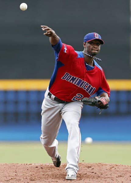 Dominican Republic starting pitcher Samuel Deduno throws in the first inning against Spain during a World Baseball Classic game in San Juan, Puerto Ri