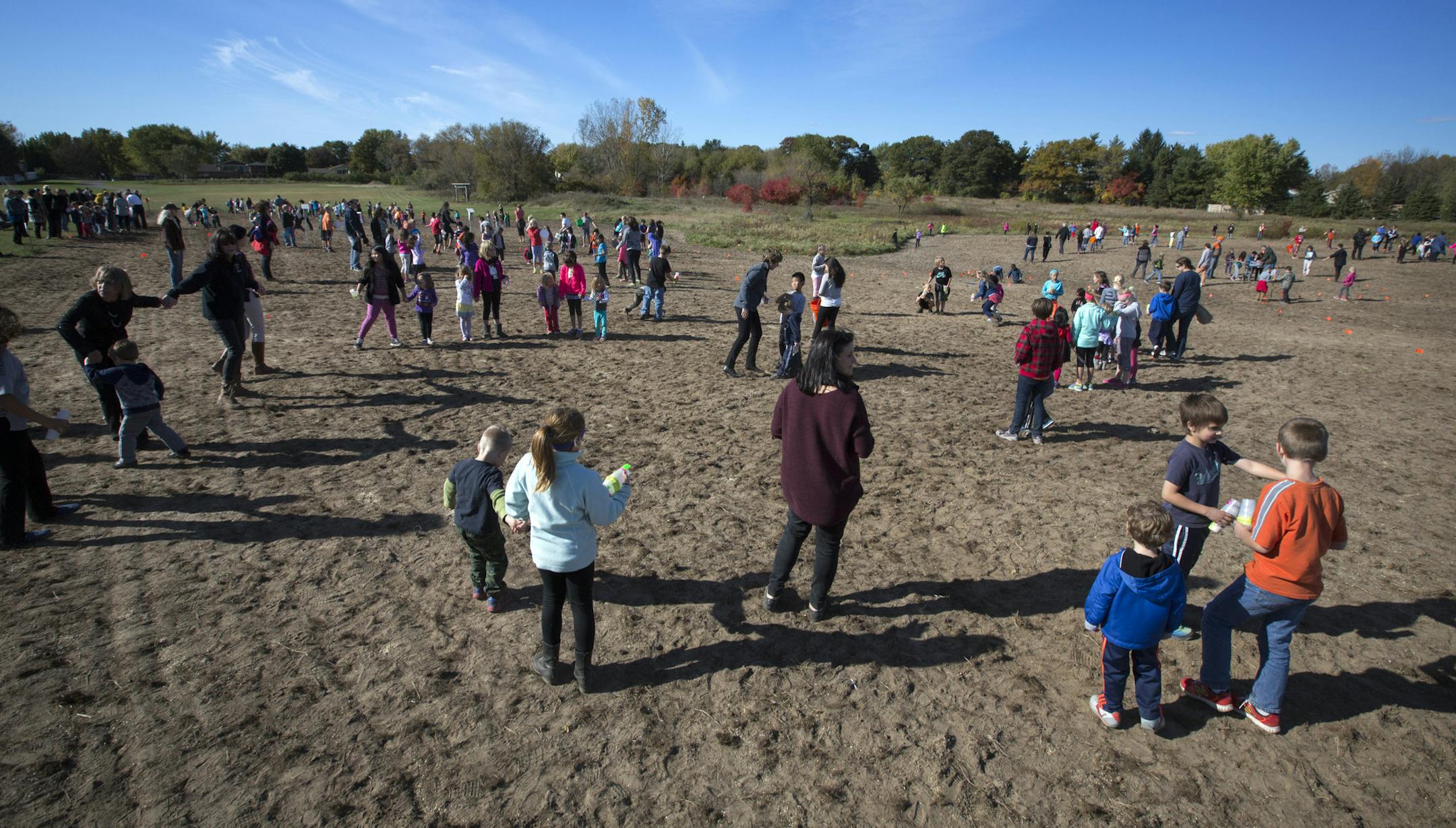 Students at Otter Lake Elementary school in White Bear Lake planted seeds for a new 2.3 acre prairie behind the school Wednesday afternoon. ] Brian.Peterson@startribune.com White Bear Lake, MN - 10/14/2015