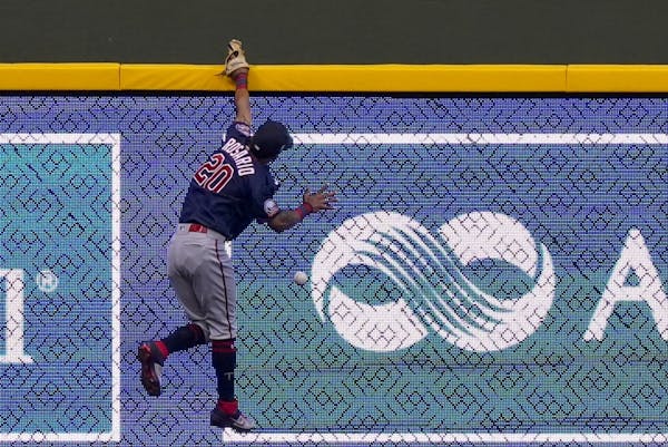 Minnesota Twins left fielder Eddie Rosario can't catch a double hit by Milwaukee Brewers' Orlando Arcia during the second inning of a baseball game Mo