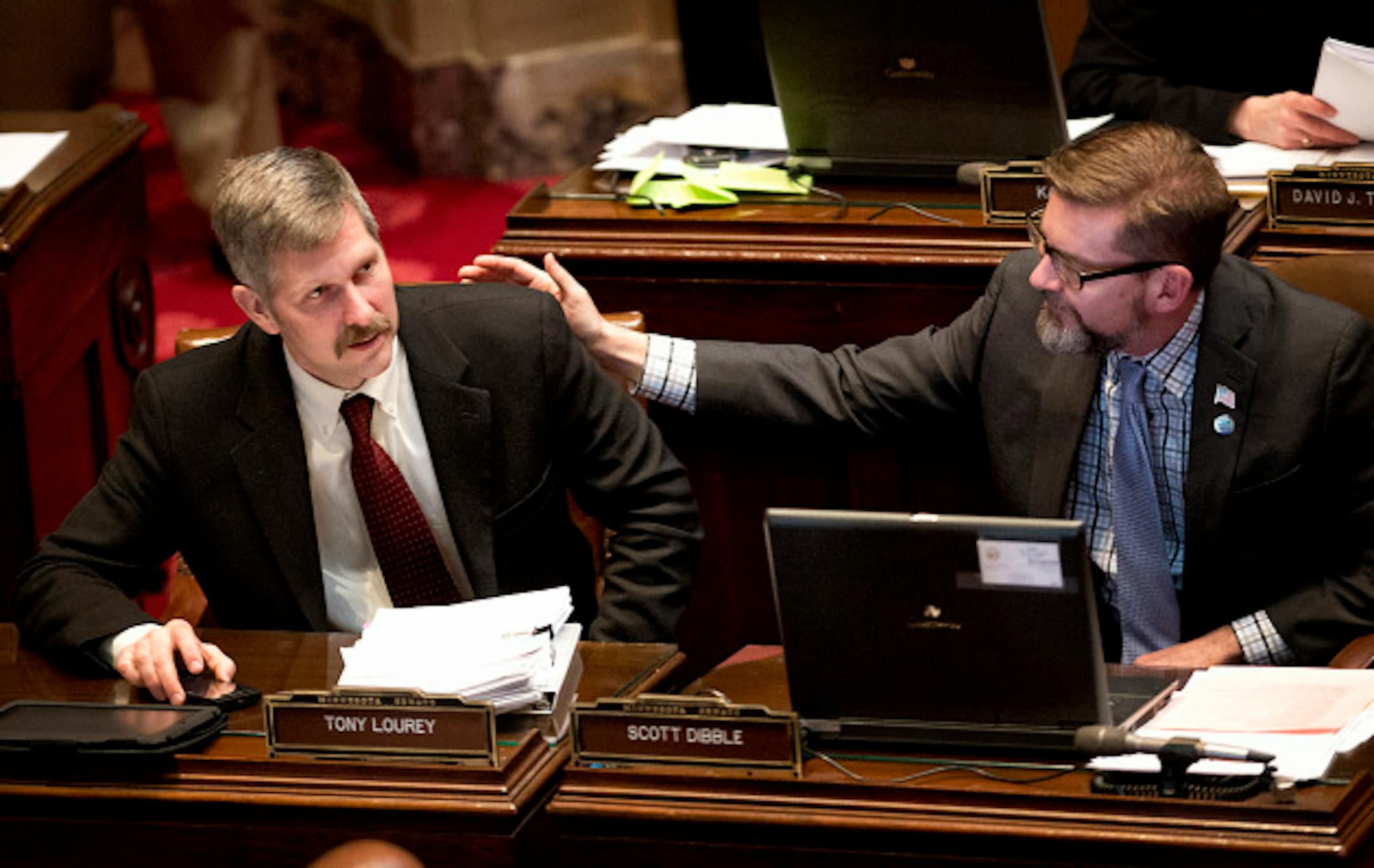 Sen Tony Dibble, right, congratulated bill author Sen. Tony Lourey after the final vote. The Minnesota Senate passed the health insurance exchange bill by a straight party line vote 39-28.  Next stop is Governor Dayton's desk.   Monday, March 18, 2013.    ]   GLEN STUBBE * gstubbe@startribune.com