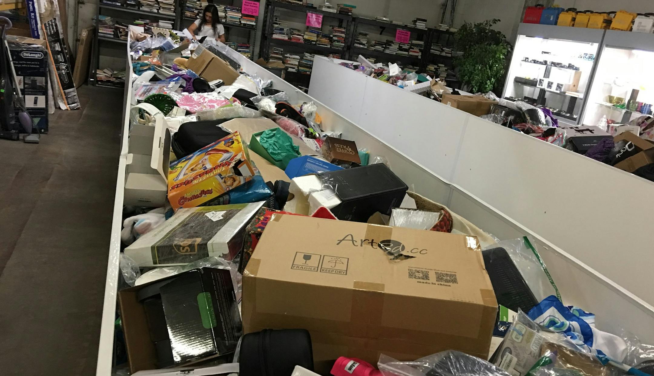 The bins at Dock 1 in Hopkins are replenished each week with new items. On Monday, those items are priced at $5. Then on Tuesday $4, until the items sell for $1 on Friday and on the Saturdays when the liquidation outlet is open. (Photo by John Ewoldt)