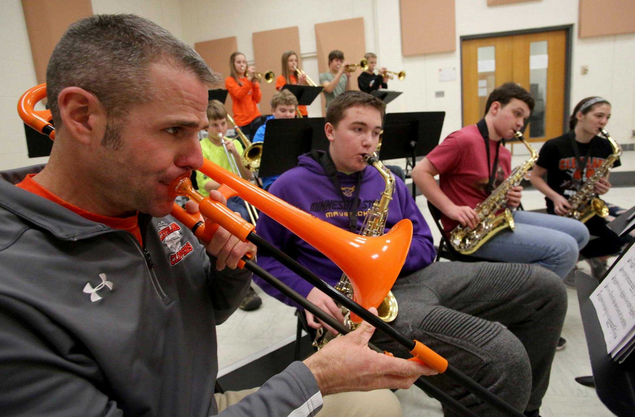 Erik Hermanson, band teacher and football coach at Cleveland Public School, leads 8th grade jazz band members in practice during lunch hour Tuesday, Feb. 21, 2017, in Cleveland, MN. Hermanson uses a cheap plastic trombone, leaving better instruments for his students.