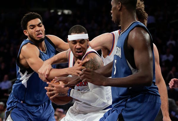 Knicks forward Carmelo Anthony, center, was double-teamed by the Timberwolves' Karl-Anthony Towns, left, and Gorgui Dieng during the fourth quarter We