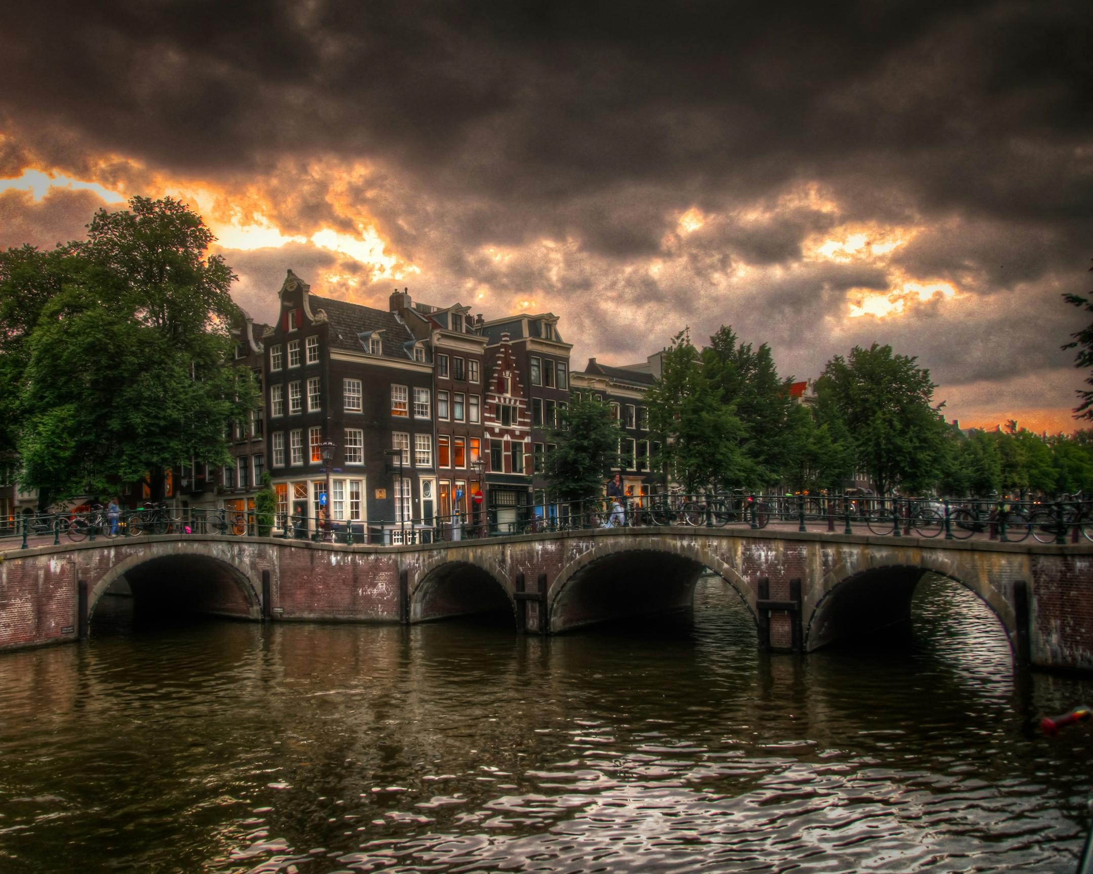 The traveler: Ryan Karlstad of Stillwater, MN The scene: Cloudy skies hasten the darkness that settles over a canal in Amsterdam at dusk. The trip: My wife, twin daughters, and I made this trip to Amsterdam about 2 years ago. My daughters were eager to see Anne Frankís house since they had just finished reading her diary in school. It was a clear bright day when we entered her home and adjacent museum, but when we left the skies had become ominous and foreboding, reflecting perhaps Anne Fra