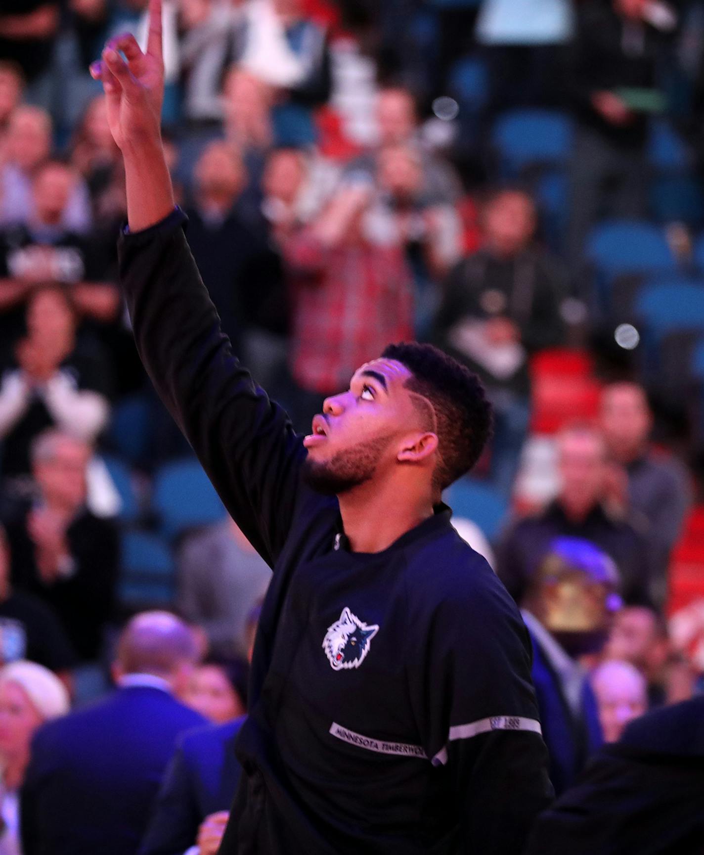 Minnesota Timberwolves forward Karl-Anthony Towns (32) points to the sky after the National Anthem. ] (Leila Navidi/Star Tribune) leila.navidi@startribune.com BACKGROUND INFORMATION: The Minnesota Timberwolves play the Memphis Grizzlies at Target Center in Minneapolis on Tuesday, November 1, 2016. ORG XMIT: MIN1611012023360337