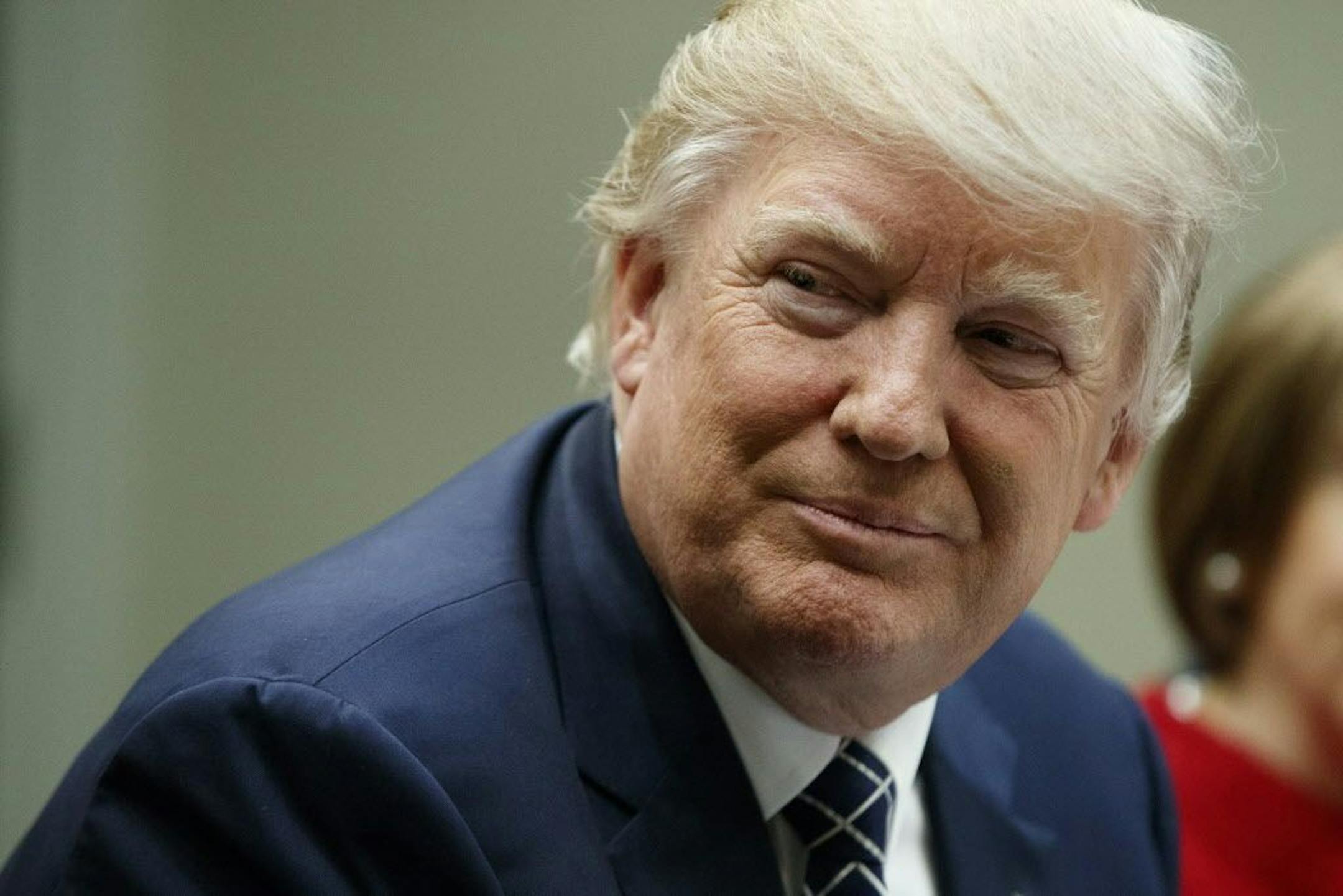 President Donald Trump listens during a meeting with leaders from small community banks, Thursday, March 9, 2017, in the Roosevelt Room of the White House in Washington.