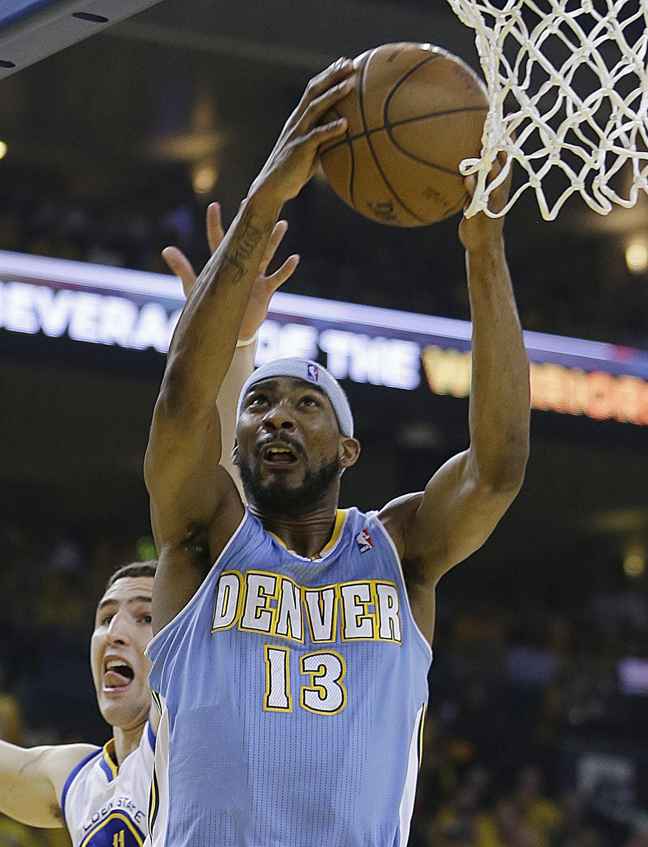Denver Nuggets' Corey Brewer (13) lays up a shot past Golden State Warriors' Klay Thompson during the first half of Game 6 in a first-round NBA basketball playoff series on Thursday, May 2, 2013, in Oakland, Calif. (AP Photo/Ben Margot) ORG XMIT: CABM106
