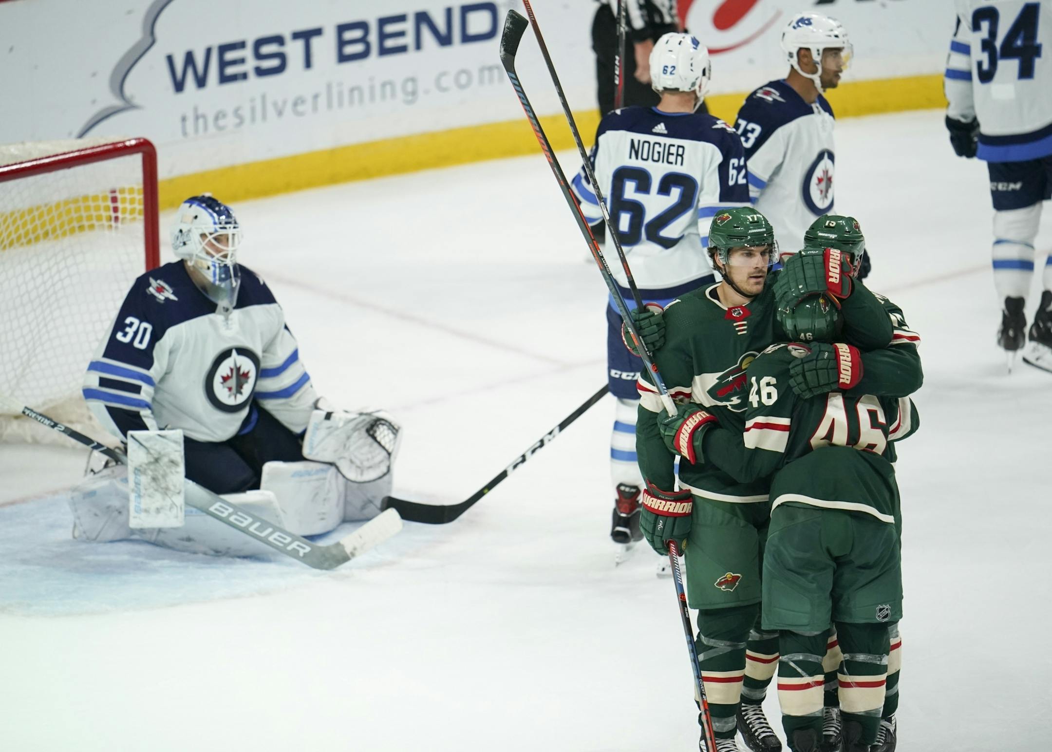 Minnesota Wild left wing Marcus Foligno (17) and Wild center Matt Hendricks (15) were first to congratulate defenseman Jared Spurgeon (46) on what proved to be the game winning goal in the third period Wednesday night.