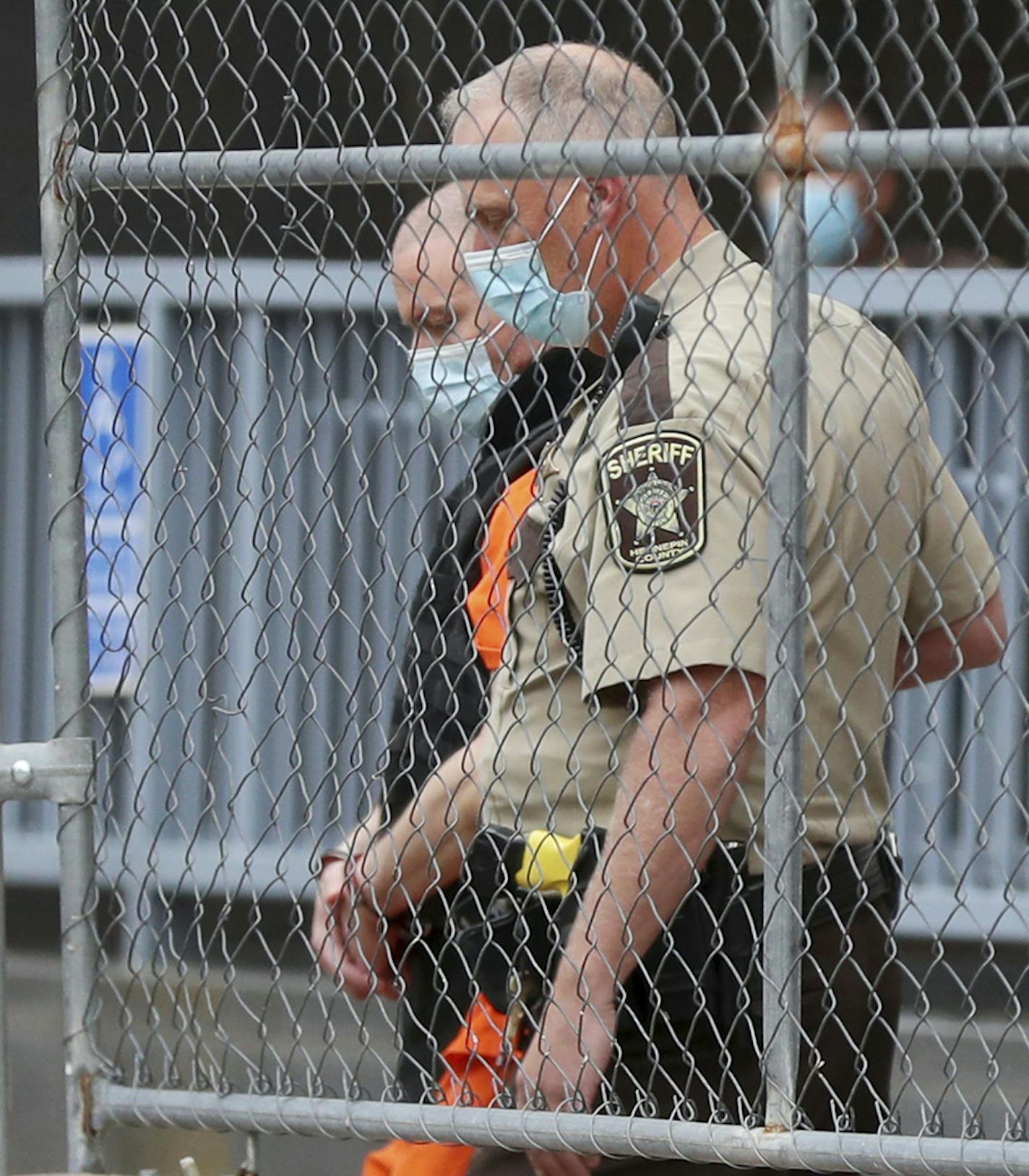 Former Minneapolis police officer Derek Chauvin is escorted from the rear of the Hennepin County Family Justice Center by a law enforcement officer after a hearing in the cases against the four former police officers in the death of George Floyd Friday, Sept. 11, 2020, in Minneapolis. Floyd died after he was restrained during his arrest on May 25 in Minneapolis. (David Joles/Star Tribune via AP)