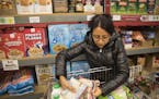 Lilia Coronel shopped for herself and her five-year-old son at the ICA Food Shelf in Minnetonka, Minn., on Monday, November 27, 2017. Coronel, who is 
