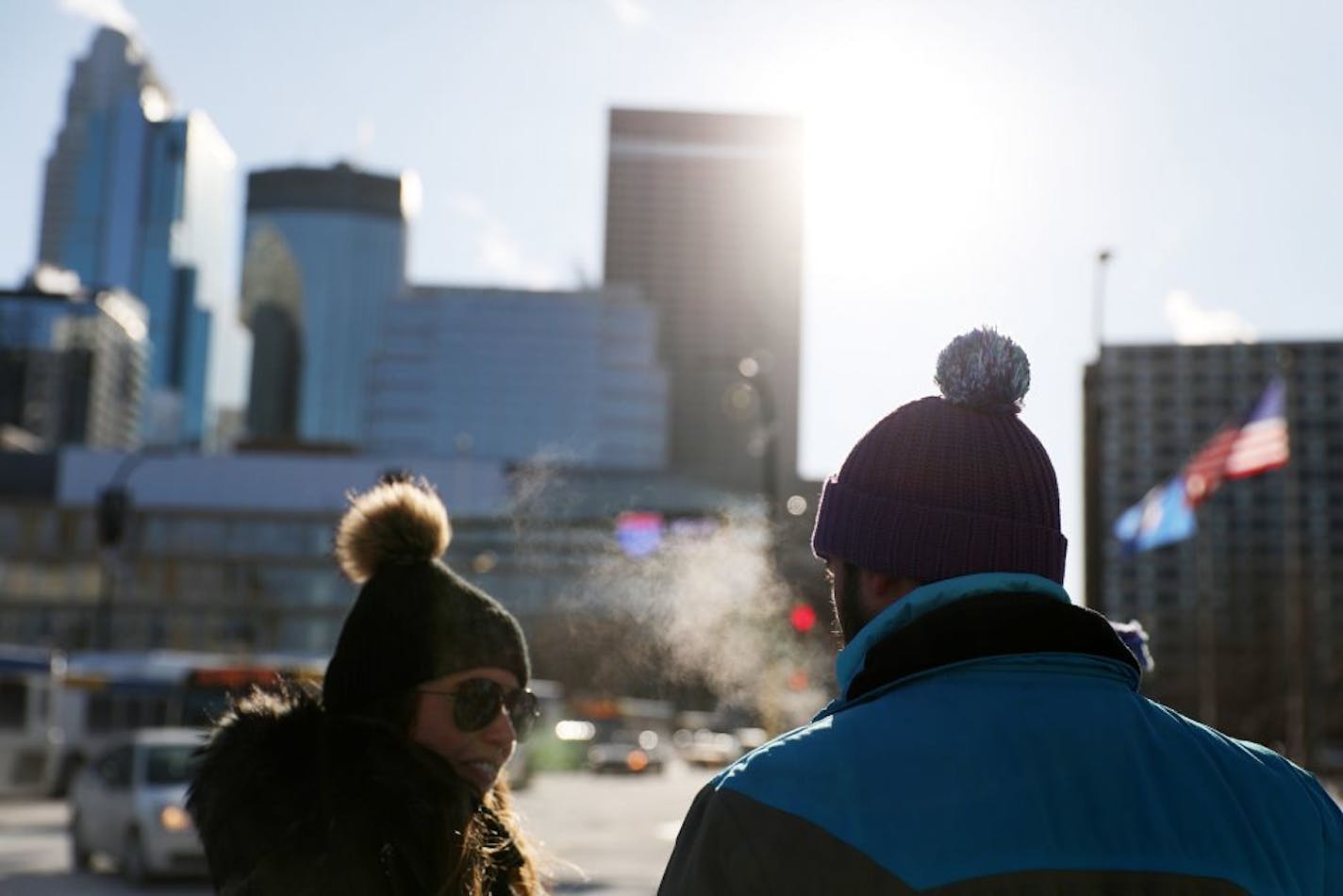 Super Bowl volunteers stood bundled up in their official gear waiting to cross South Washington Avenue Thursday.