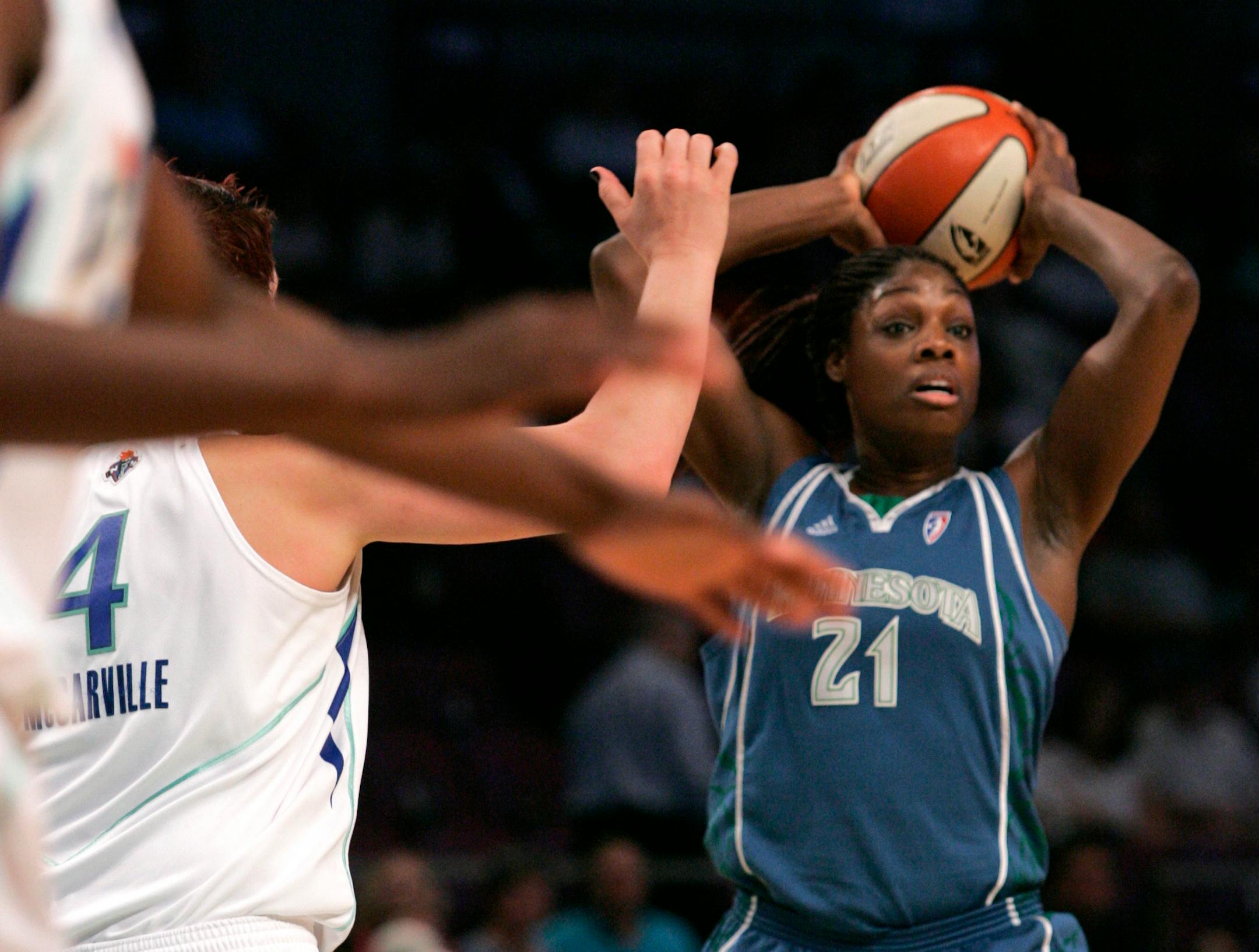 Minnesota Lynx's Nicky Anosike (21) looked to pass away from New York Liberty's Janel McCarville (4) Saturday in New York.