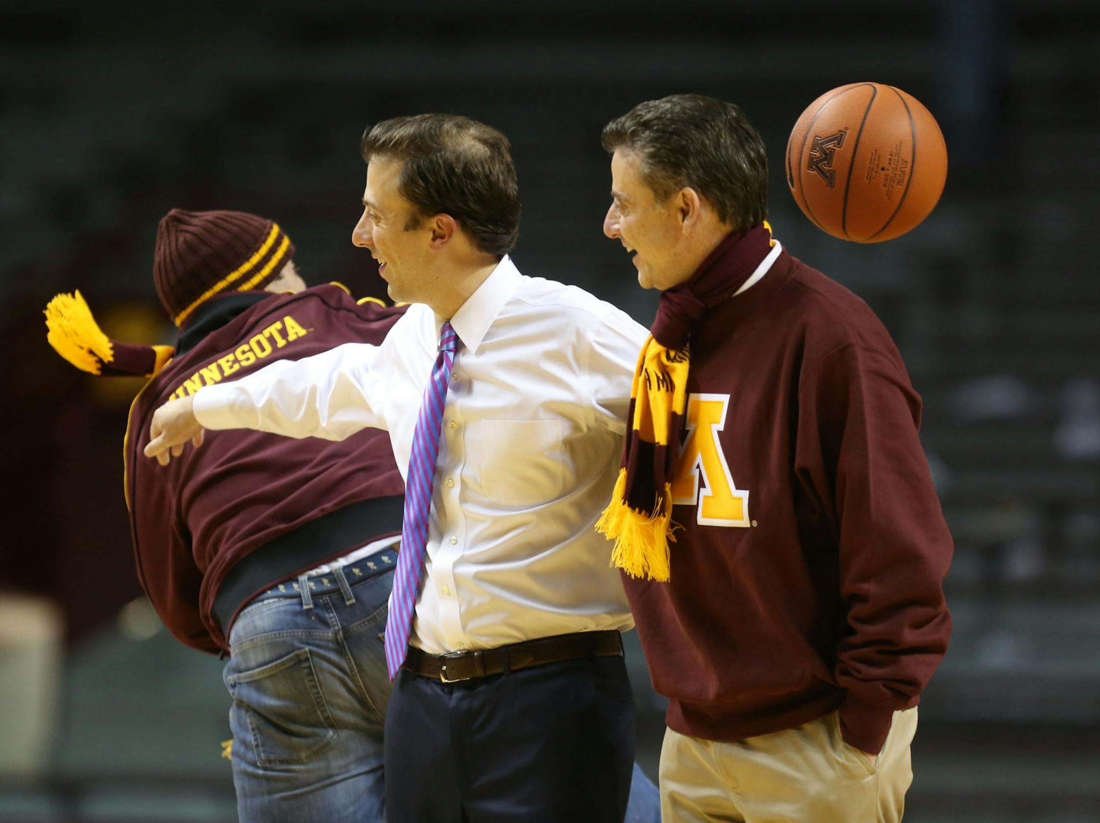 Richard Pitino tried to shoo his brother Michael away as Richard tried to take a photo with his dad Rick after their win against South Dakota State at Williams Arena in Minneapolis Tuesday, December 10, 2013. Gophers won over South Dakota State 75-59.