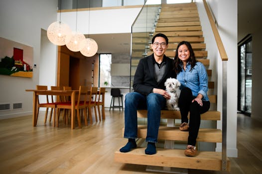 Vincent Jusuf and Catherine Pham relax in their Minneapolis home with their 11-year-old Shih Tzu, Chili.