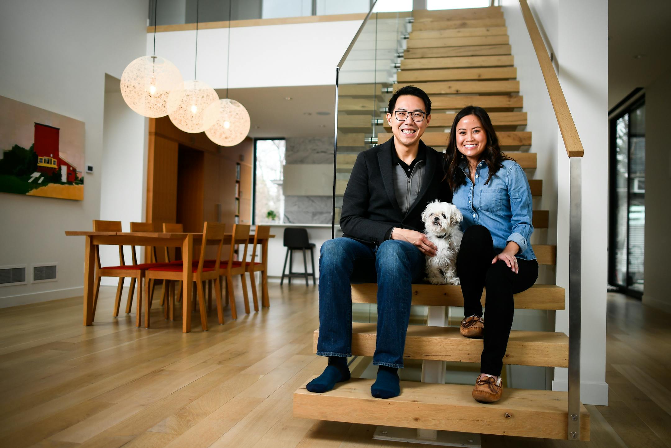 Vincent Jusuf and Catherine Pham relax in their Minneapolis home with their 11-year-old Shih Tzu, Chili.
