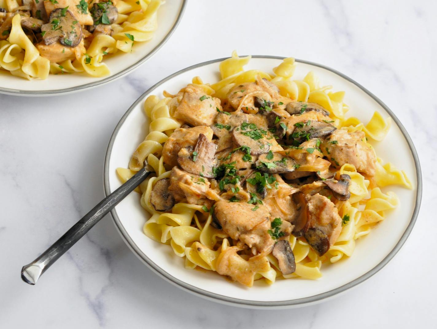 Image of Chicken and Mushroom Stroganoff, a classic comfort food made with chicken, mushrooms, and a sour cream-based sauce