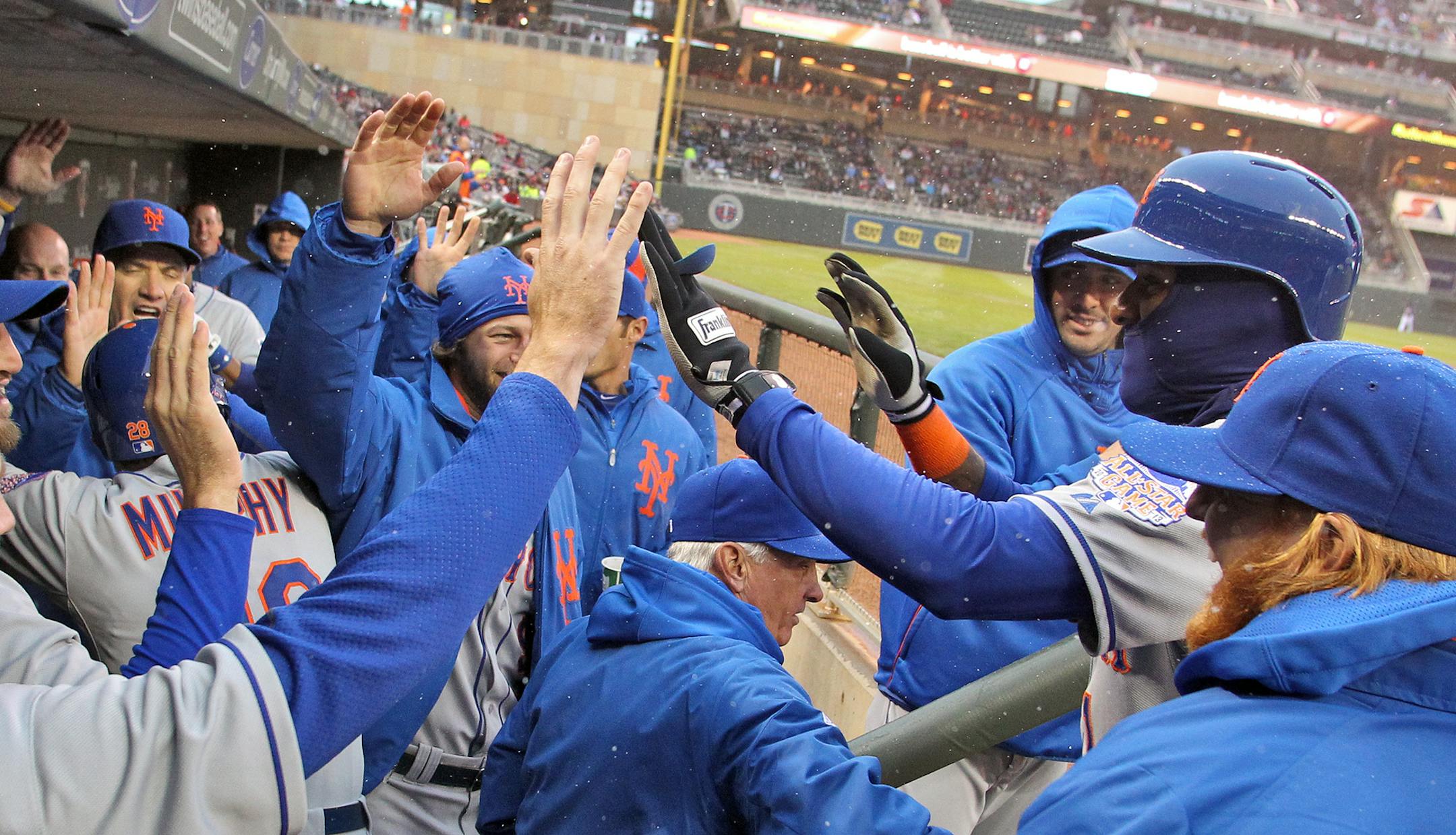 Jordany Valdespin, wearing a ski mask was congratulated by teammates in the dugout after he scored a run in first inning action.