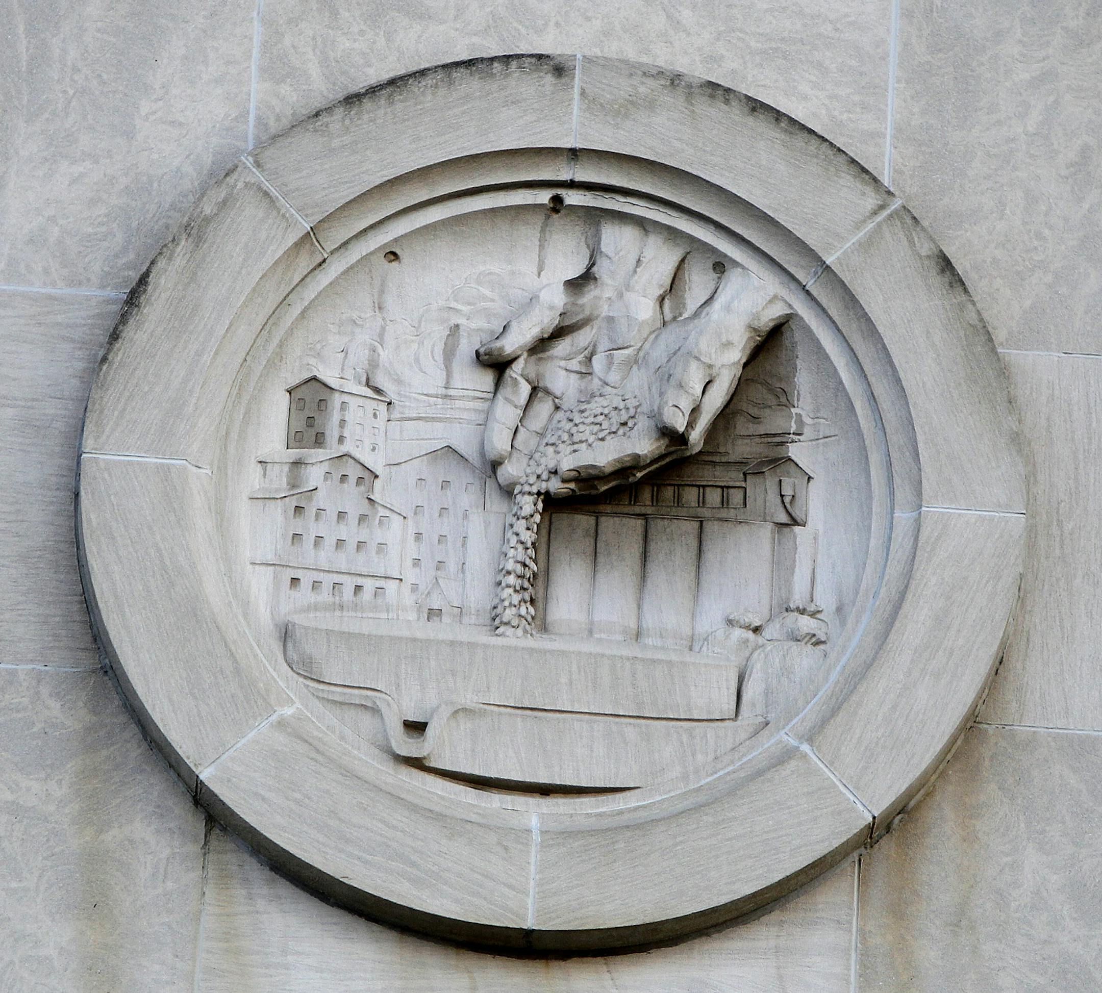 Construction crew from Ryan were beginning the process of removing medallions from front of Star Tribune building, Monday, February 10, 2014 in Minneapolis, MN. ] (ELIZABETH FLORES/STAR TRIBUNE) ELIZABETH FLORES • eflores@startribune.com