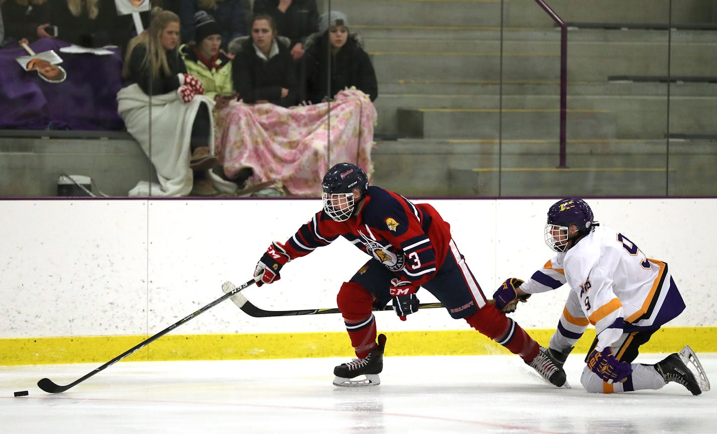 Davey Burns, left, of Orono and Ayden Rakos of Waconia chase the puck.