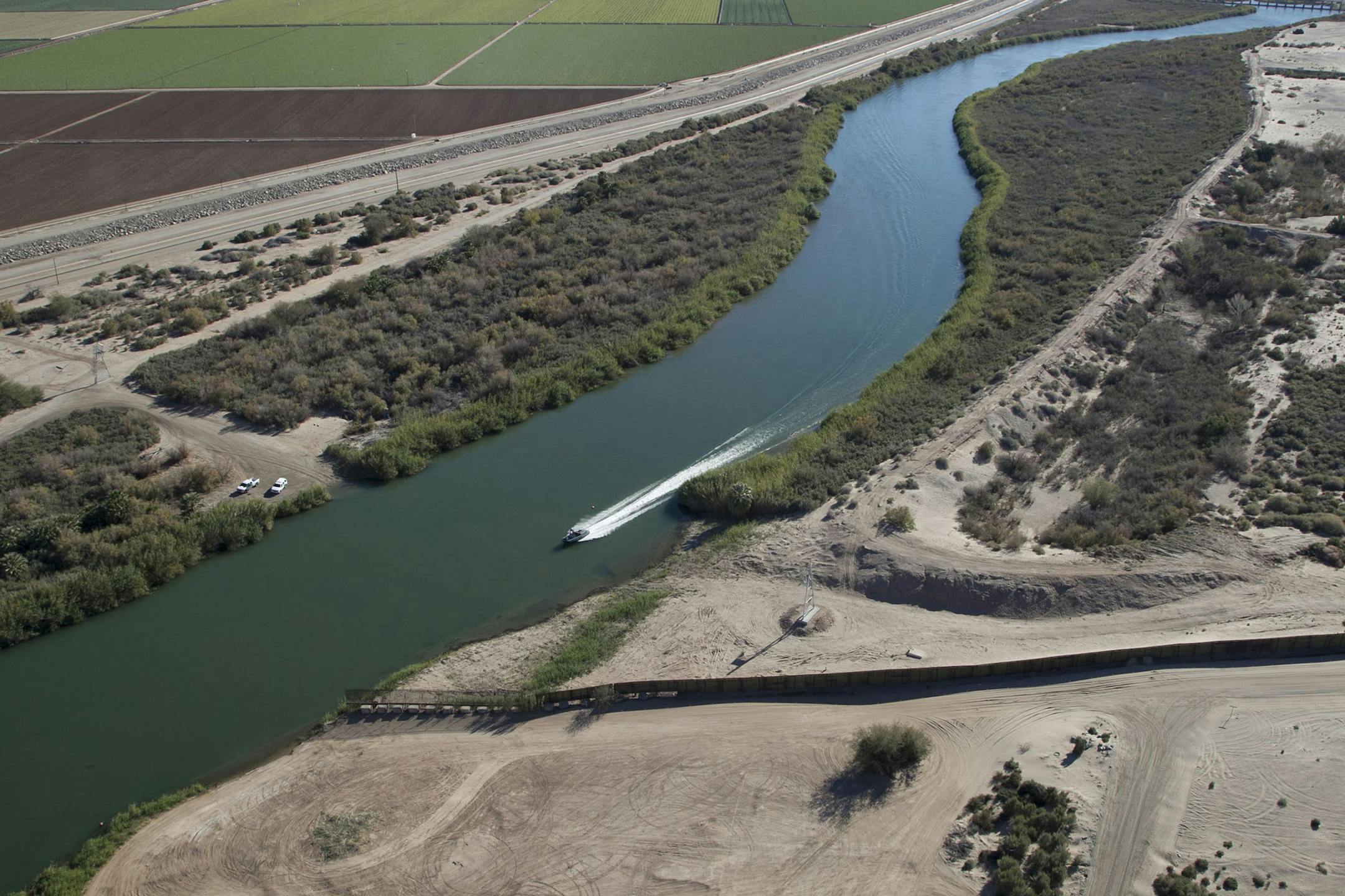 A Border Patrol patrol boat headed north on the Colorado River, where the fence ends between Arizona and California.