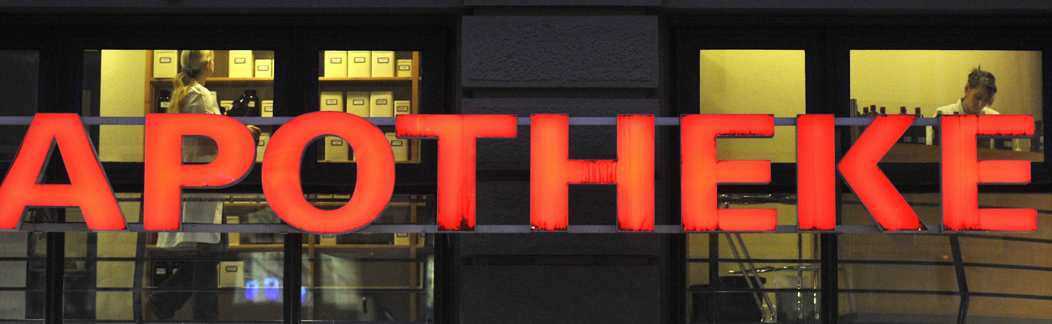 Employees work in a pharmacy in Berlin's Mitte district in a 2008 file image. Germany has struggled much less with opioid addiction than the United States. (John Macdougal/AFP/Getty Images/TNS) ORG XMIT: 1508799