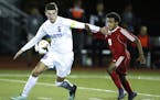 St. Thomas Academy senior William Mayleben, left, kept the ball away from St. Paul Highland Park's Abdi Gutu during the Class 1A, Section 3 semifinals
