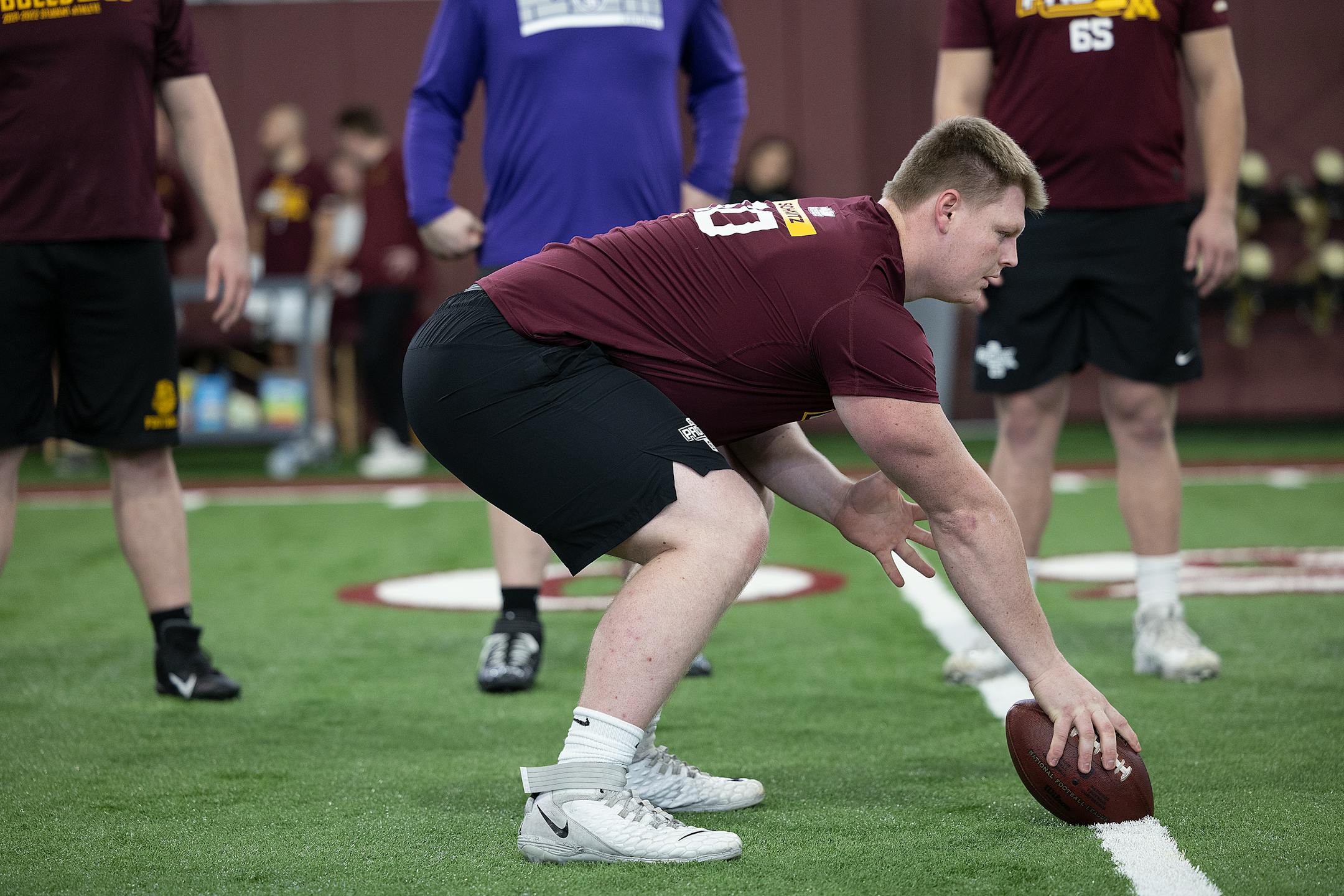 Minnesota Center John Michael Schmitz works out for scouts during the Minnesota Pro Day.