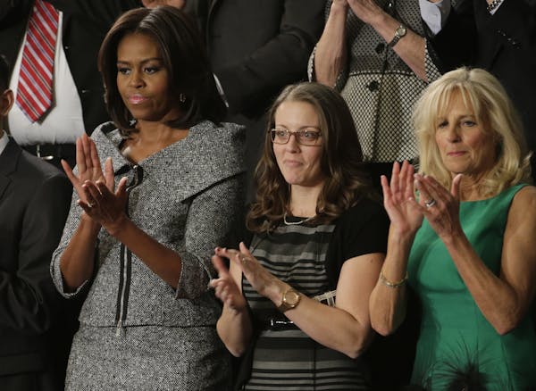 First lady Michelle Obama applauds on Capitol Hill in Washington, Tuesday, Jan. 20, 2015, before President Barack Obama's State of the Union address b