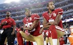 FILE - In this Monday, Sept. 12, 2016, file photo, San Francisco 49ers safety Eric Reid (35) and quarterback Colin Kaepernick (7) kneel during the nat